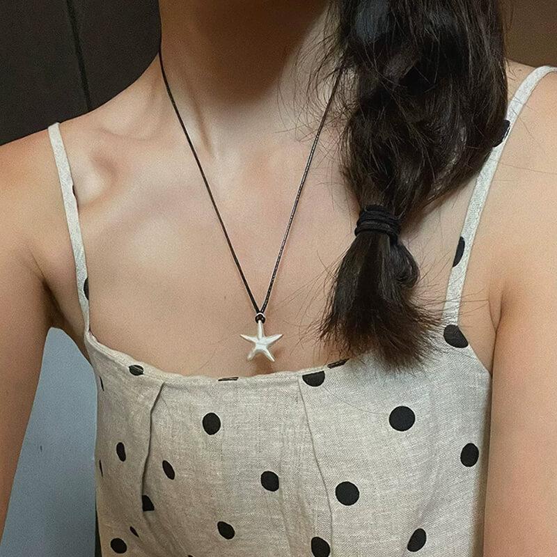 Original S990 Silver Starfish Necklace – Handmade Sandblasted Matte Finish with Black Cord — A minimalist starfish pendant in hand-sandblasted S990 silver, phot