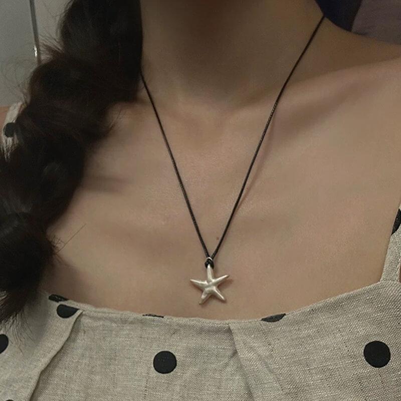 Original S990 Silver Starfish Necklace – Handmade Sandblasted Matte Finish with Black Cord — A minimalist starfish pendant in hand-sandblasted S990 silver, phot