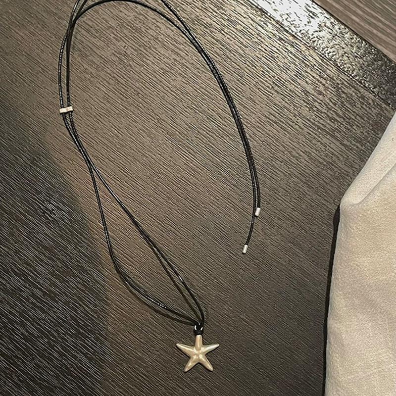 Original S990 Silver Starfish Necklace – Handmade Sandblasted Matte Finish with Black Cord — A minimalist starfish pendant in hand-sandblasted S990 silver, phot