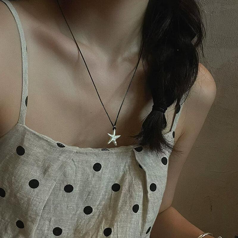 Original S990 Silver Starfish Necklace – Handmade Sandblasted Matte Finish with Black Cord — A minimalist starfish pendant in hand-sandblasted S990 silver, phot